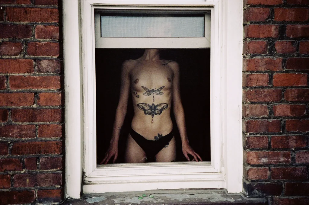 Photo of nude woman in window with the Yashica Ninja Star II AF-J2