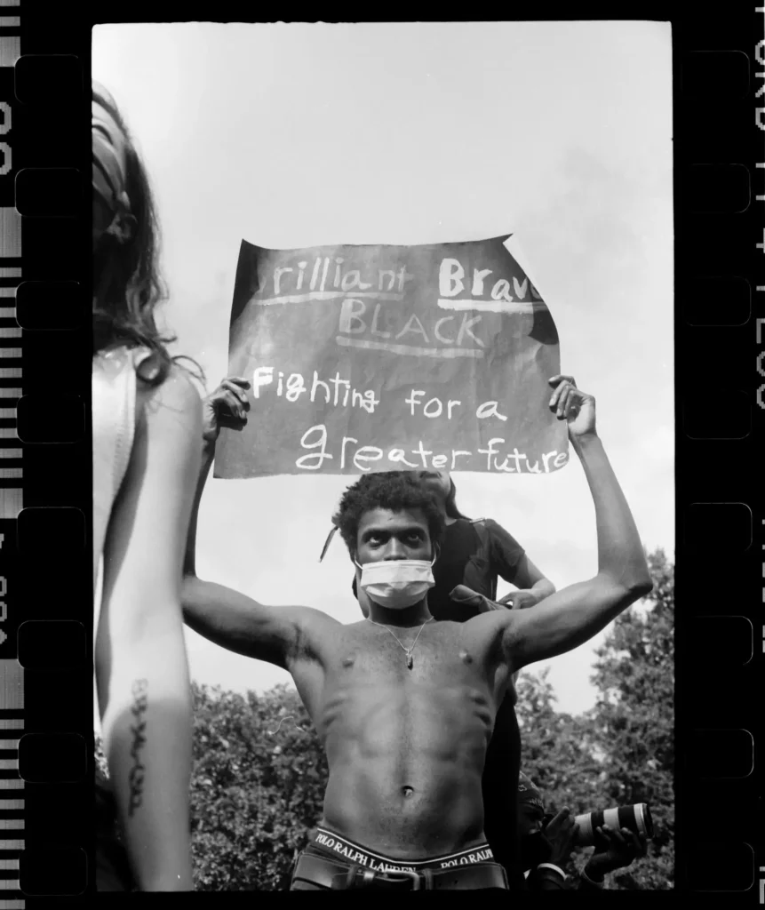 Man holding up a sign in Washington Square Park