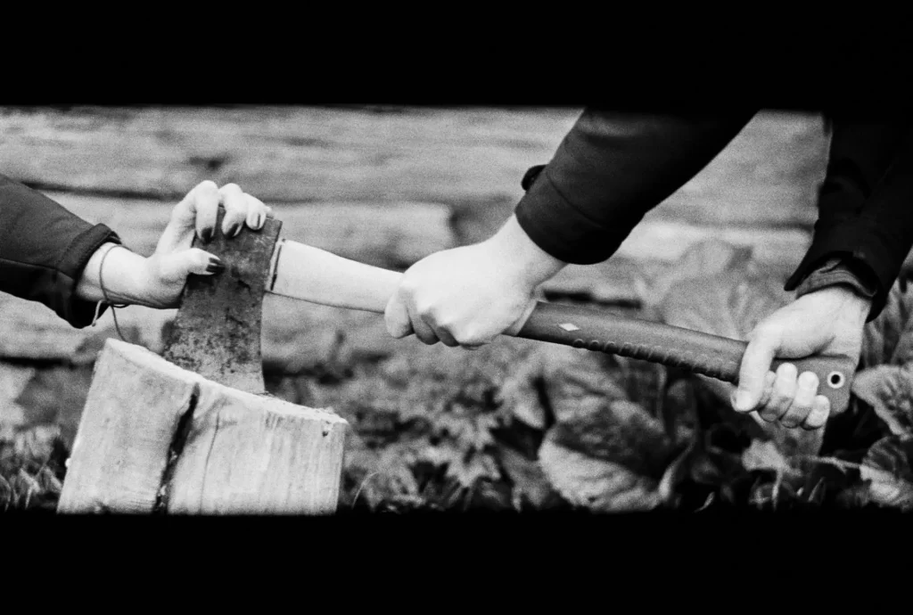 axe with hands on film