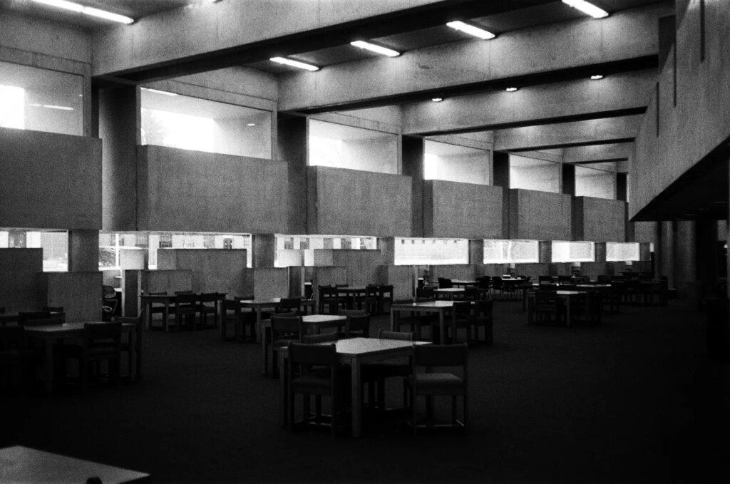 The interior of a library with tables and chairs