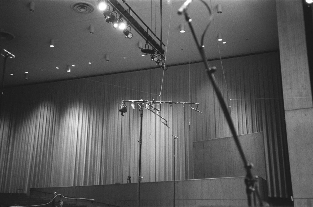 Microphones suspended above an orchestra