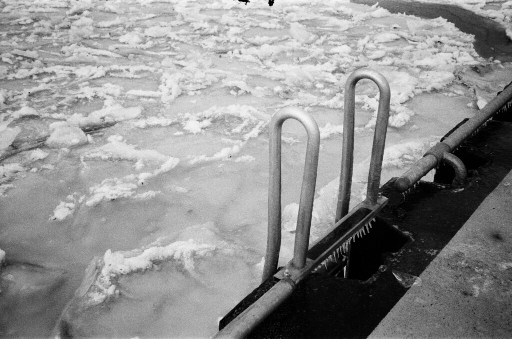 A ladder leading down to a frozen lake