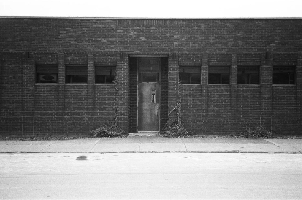 A brick storefront of an abandoned building