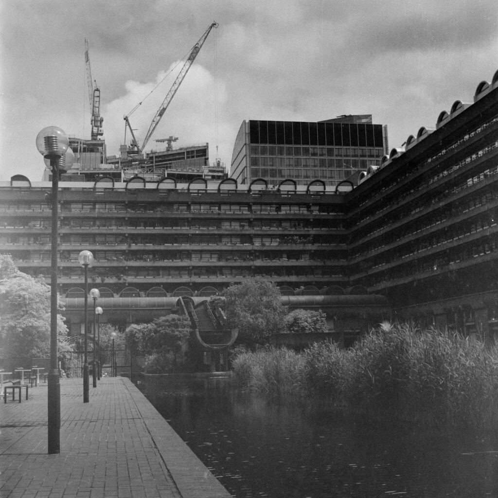Black and white photo of the Barbican, London, and its ornamental lake 