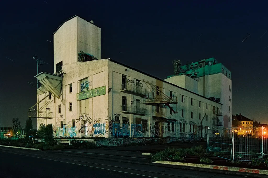 abandoned silo building shot at night on CineStill film