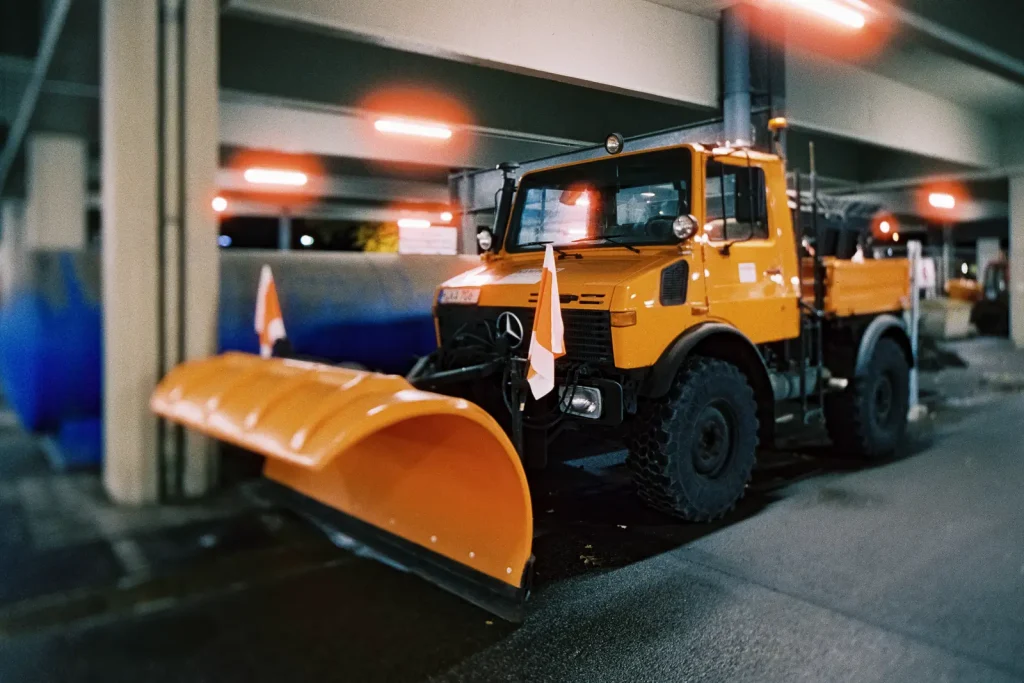 Orange snowplow (Mercedes Unimog) shot at night on CineStill film