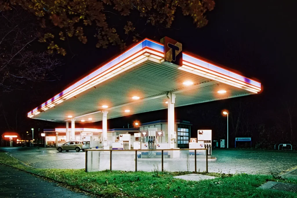 blue and red decorated filling station shot at night on CineStill film
