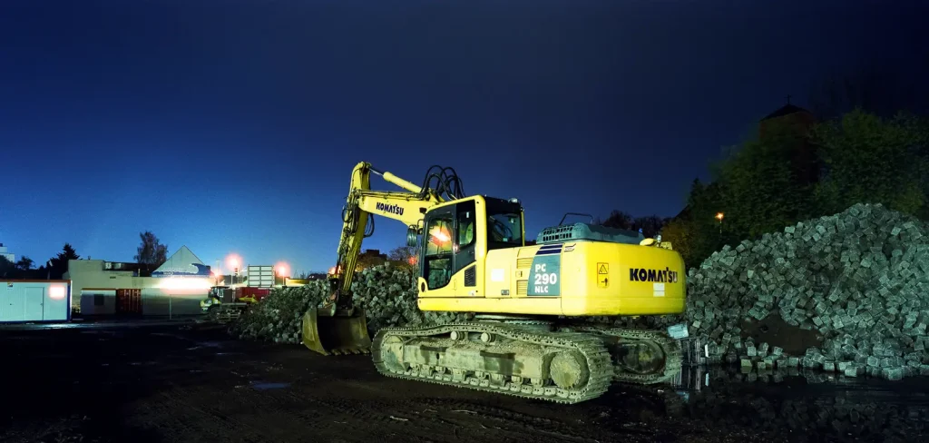 yellow excavator shot at night on CineStill film
