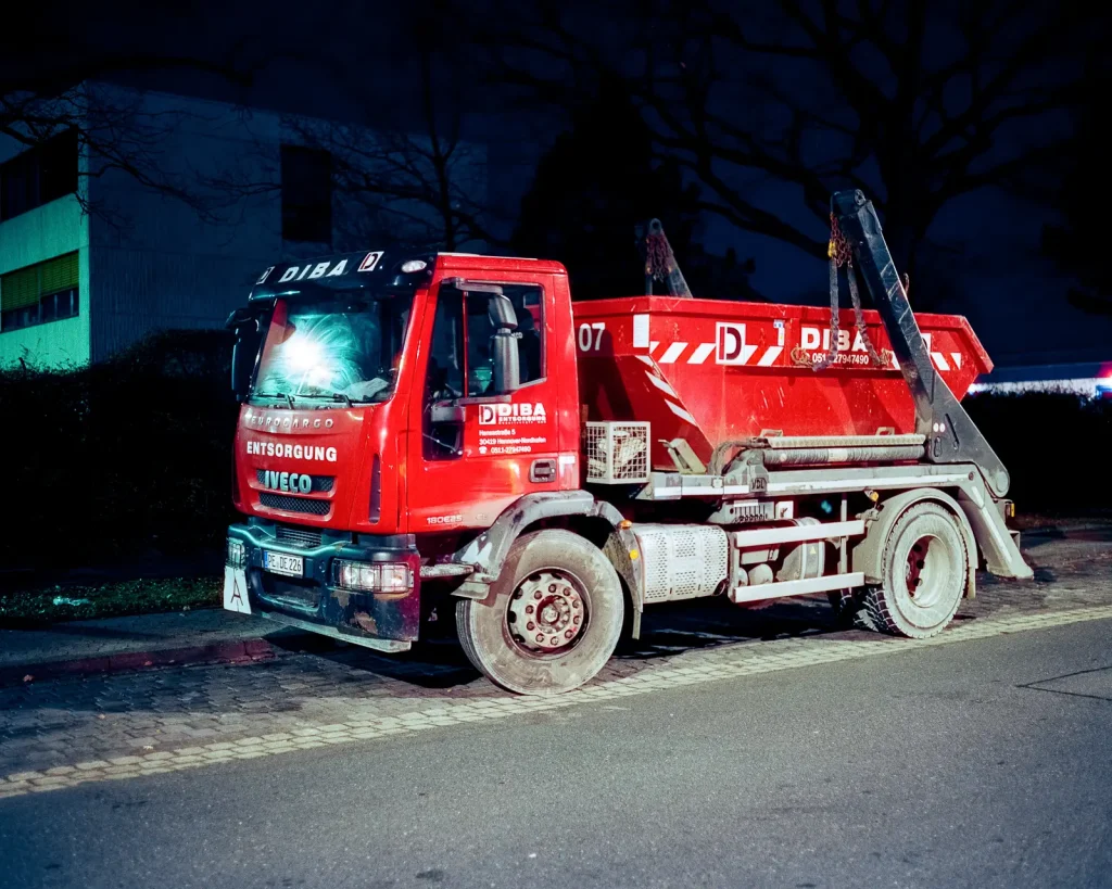 red dumpster truck shot at night on CineStill film