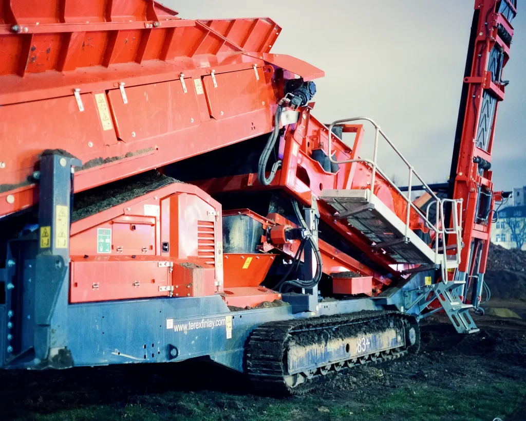 close-up of red construction machine shot at night on CineStill film