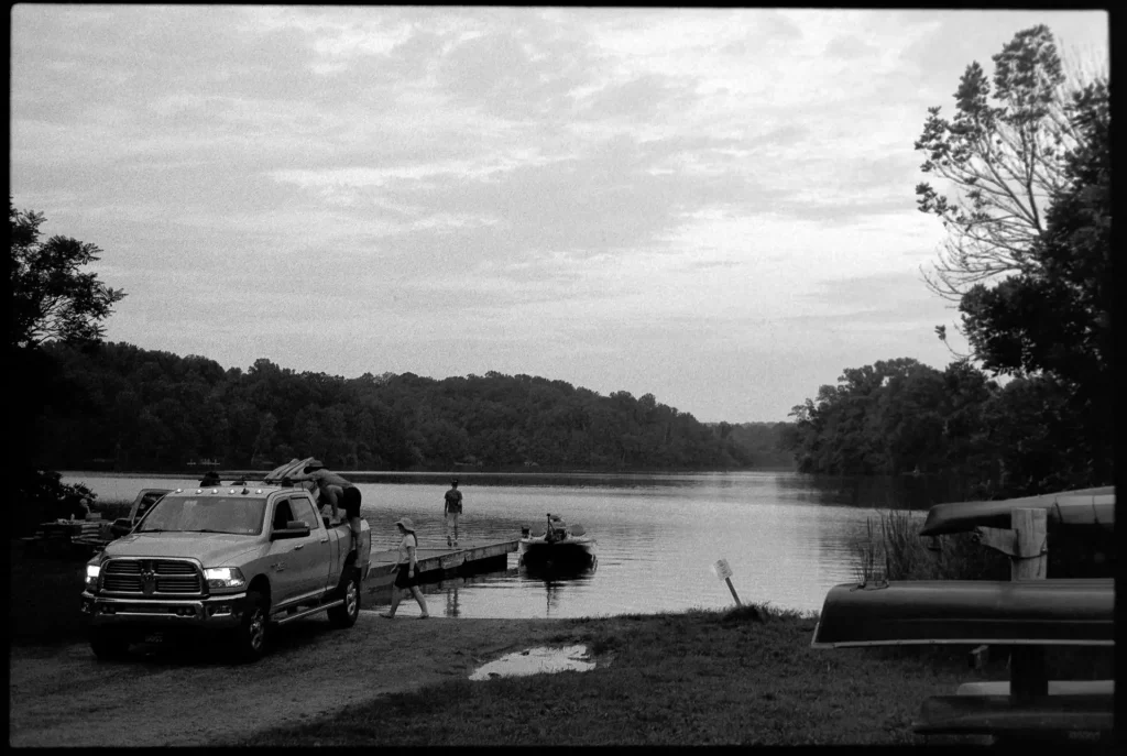 Family packing up jeep at the lake