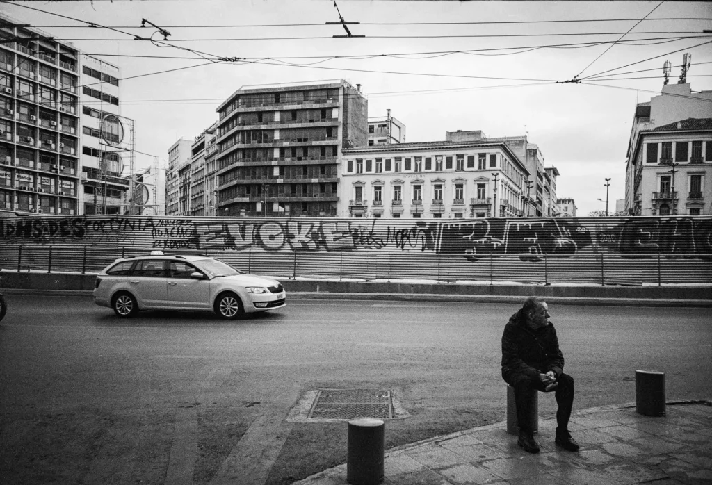 Man sitting by roadside - lomo lc-a