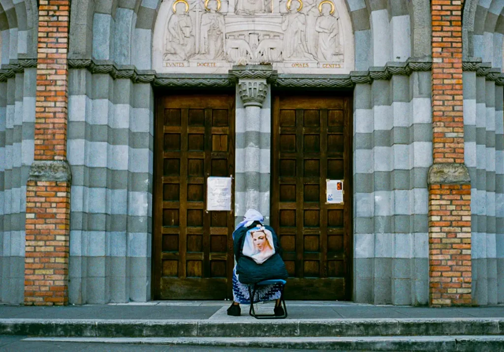 Lady prays outside of her closed church during lockdown