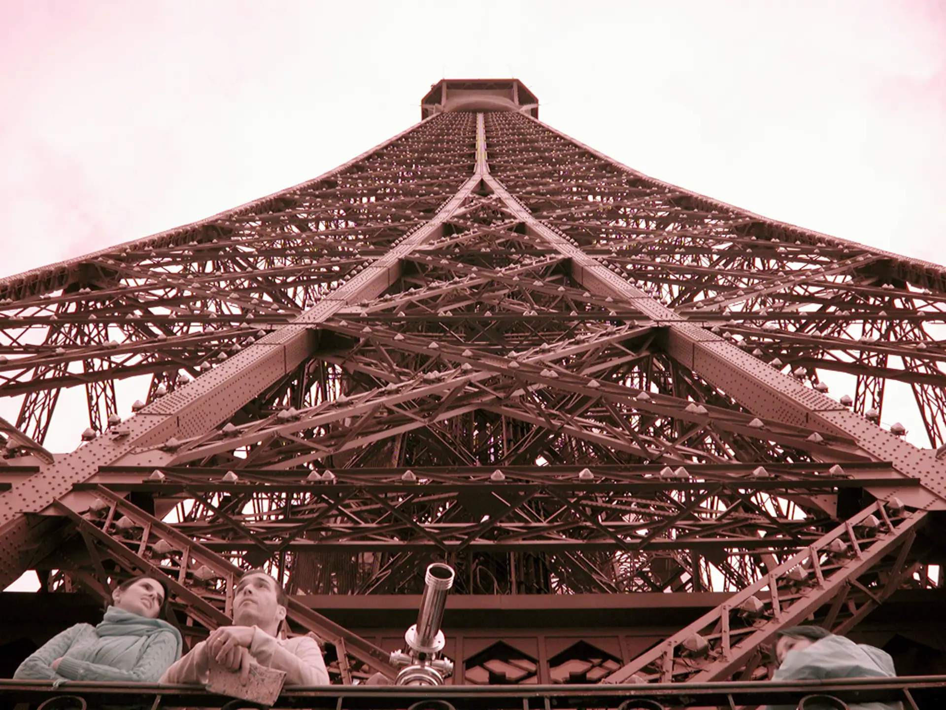 A couple looking out toward Paris from the Eiffel Tower