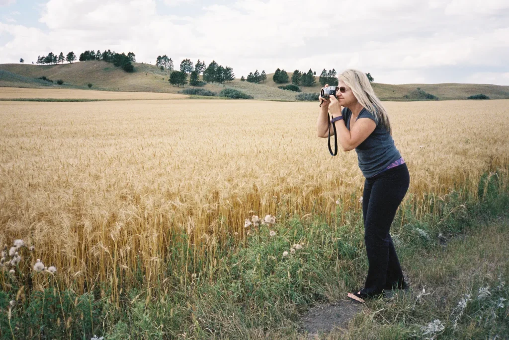 Manual Zoom - Portra 400, Eve leaning in to zoom her fixed lens X100s 6" closer for the perfect landscape shot.