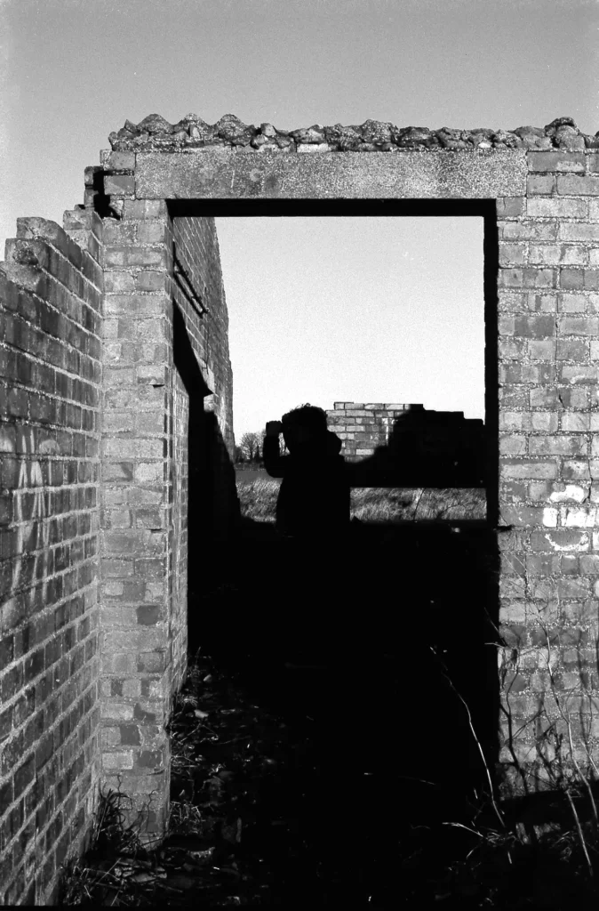 Subject stood in the centre of RAF Grimsby ruins creating them into a silhouette.