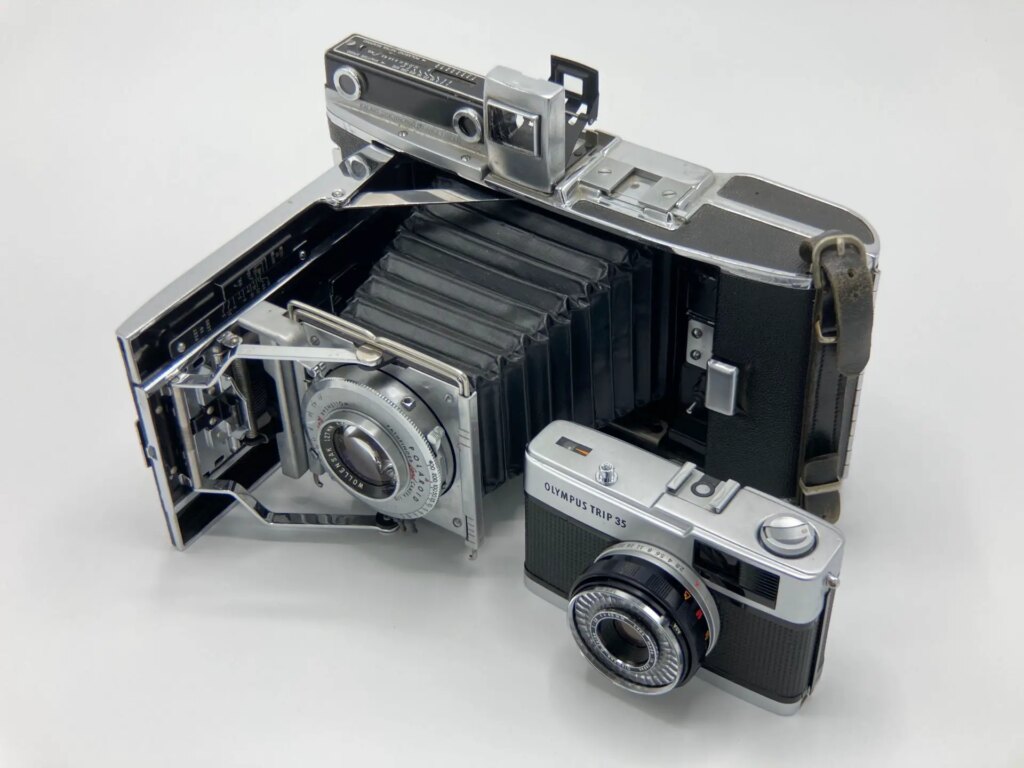 A Polaroid Pathfinder 110 camera, with an Olympus Trip 35 next to it for scale