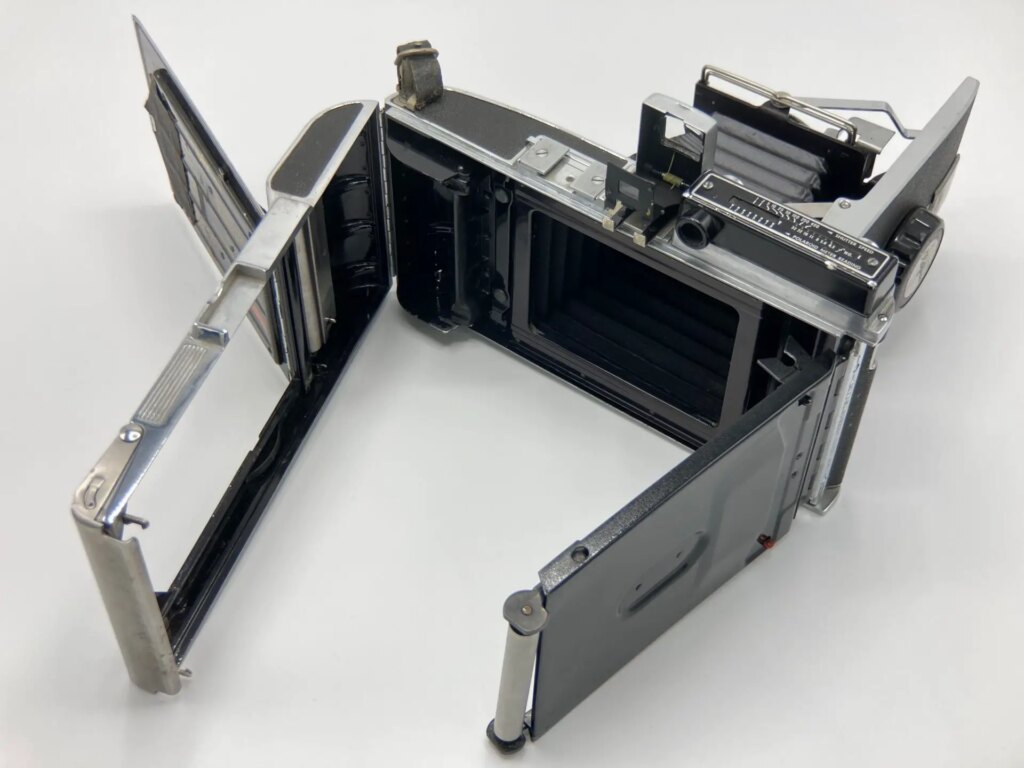Rear view of a Polaroid Pathfinder 110 camera with the doors open