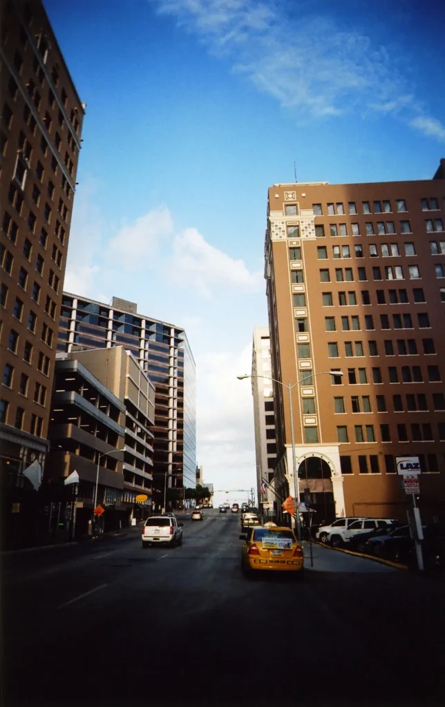 Yellow cab on the streets in Austin, Texas, taken with a White Slim Angel ultra wide 35mm point and shoot film camera.