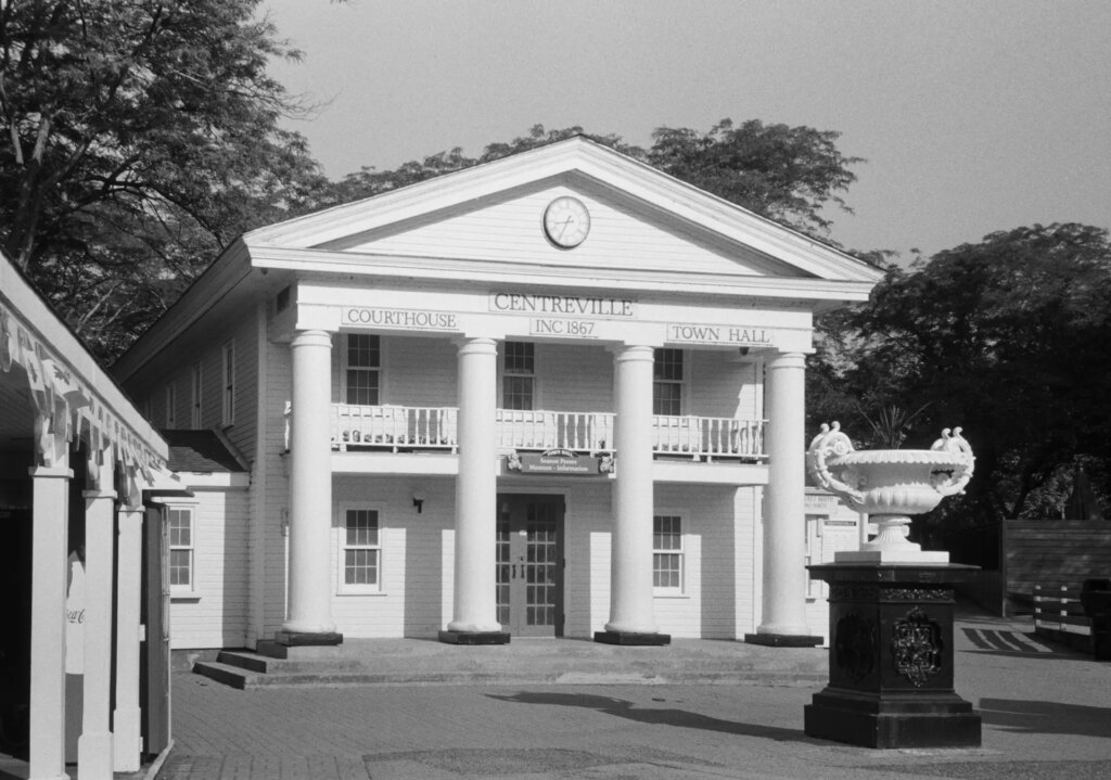 Old white building with a portico and columns