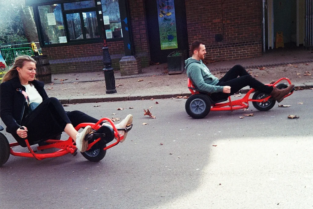 A couple on low lounge bikes, having fun in Battersea Park