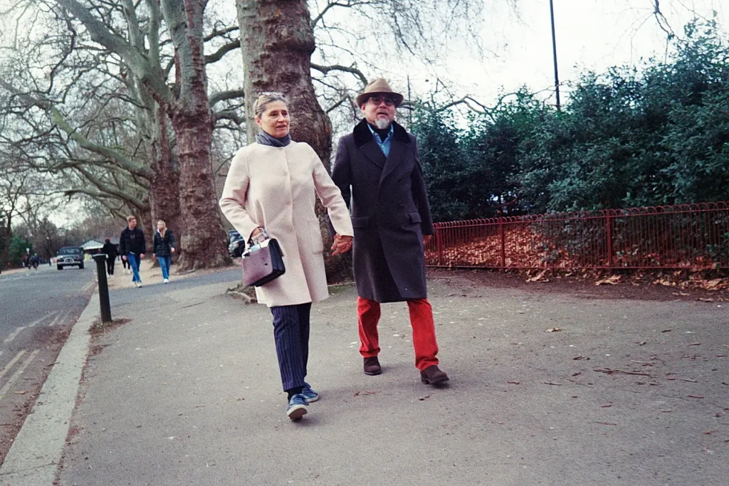 Stylish older couple walking along the pedestrian path in Battersea park