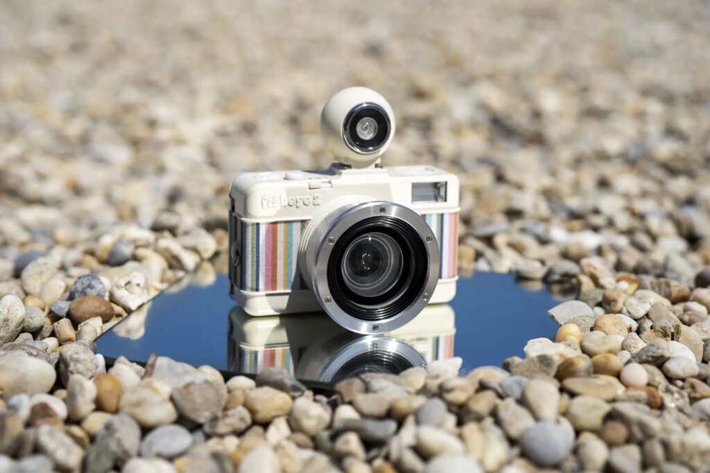 lomography fisheye placed on a mirror on a small rocky section of beach on a sunny day