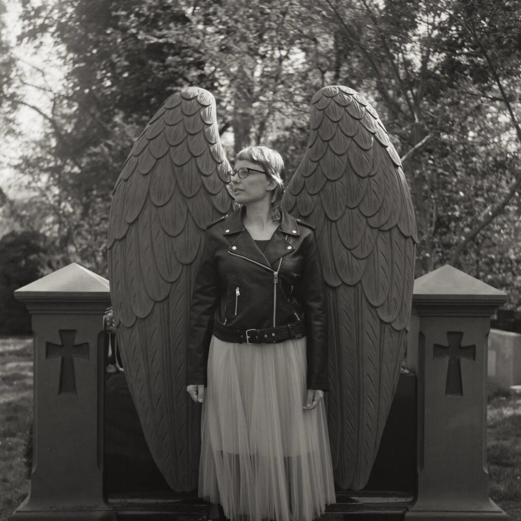 Portrait of a woman beside a monument