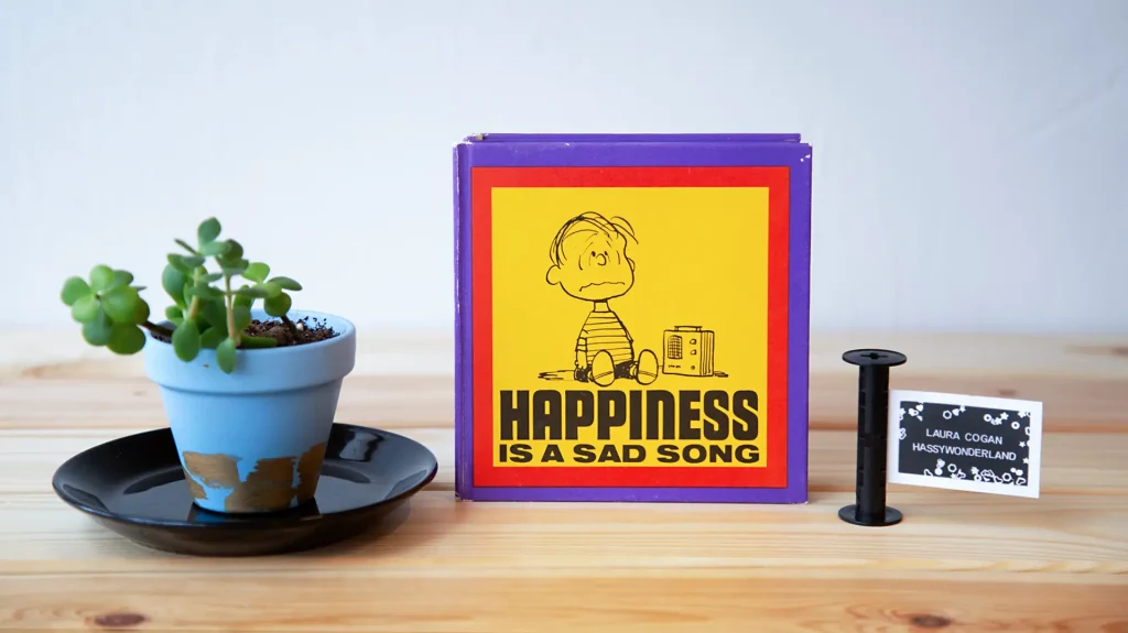 Happiness is a sad song with four darkroom prints inside