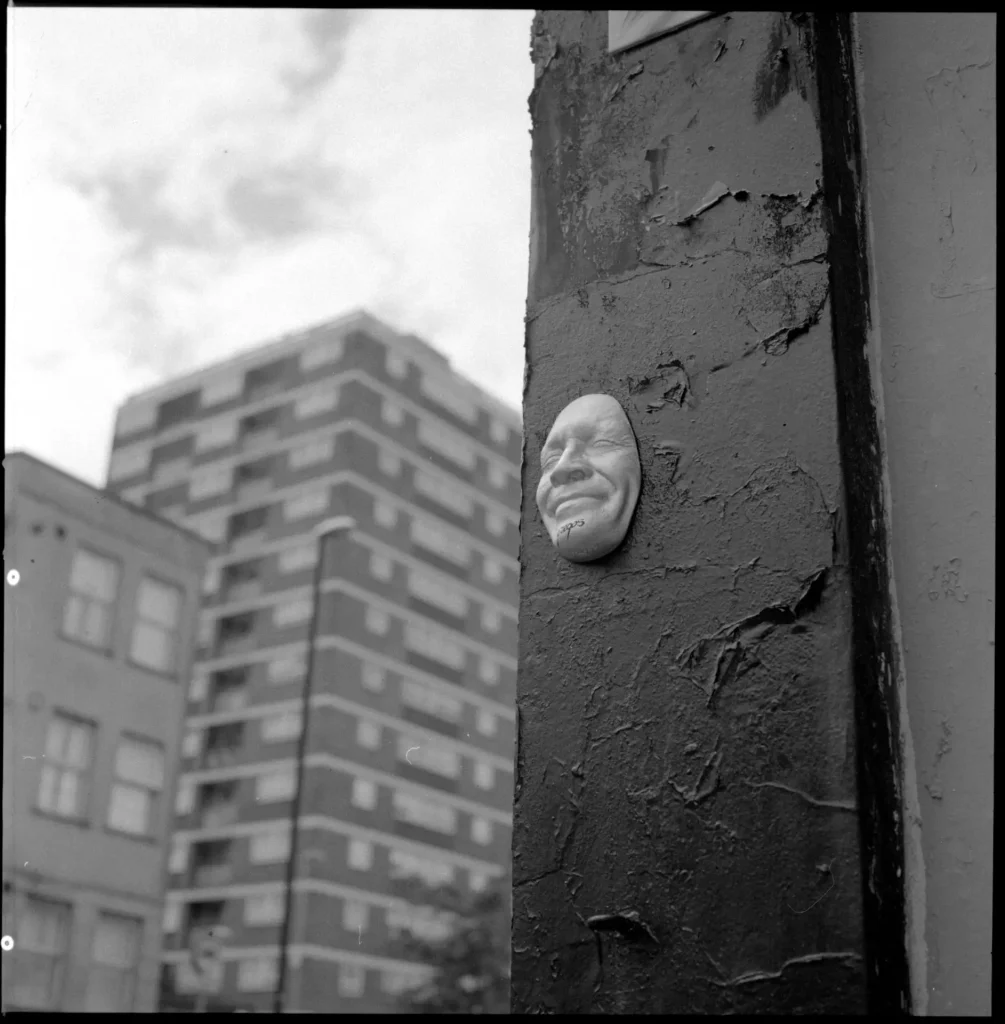 smiling face street art on wall
