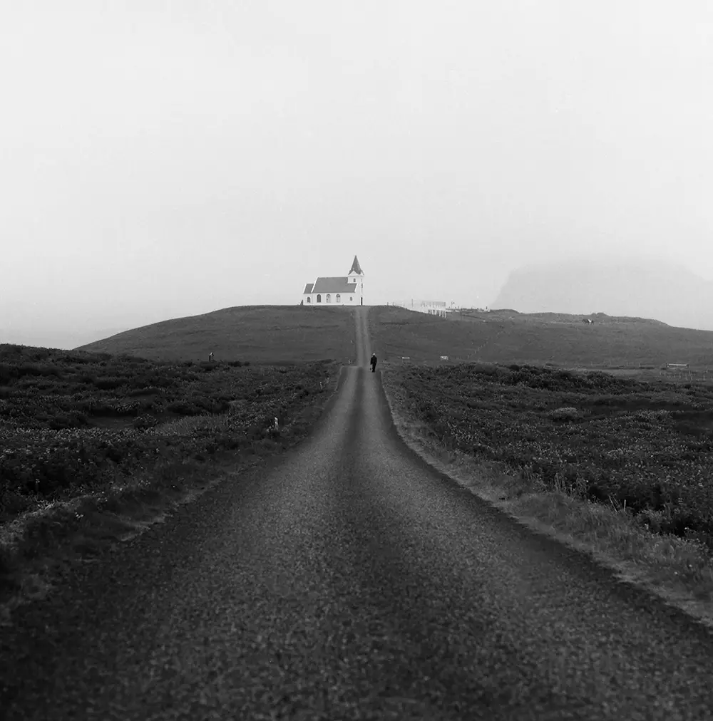 man in road and church