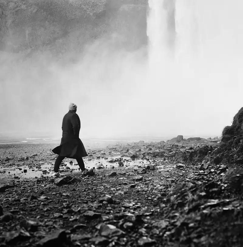 man at waterfall