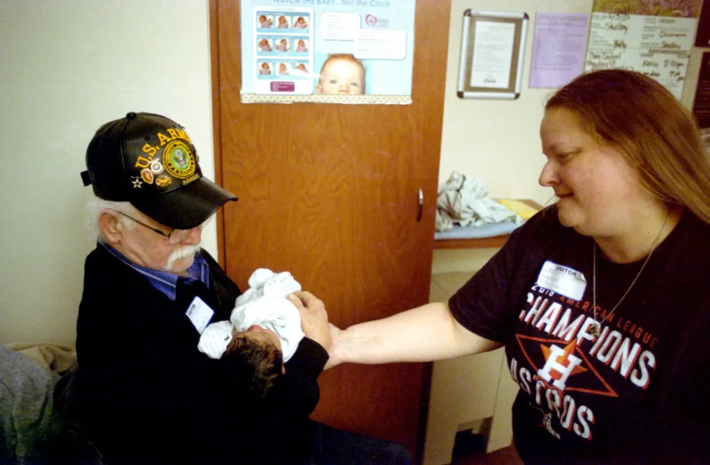 My mother in-law handing Micah to her father