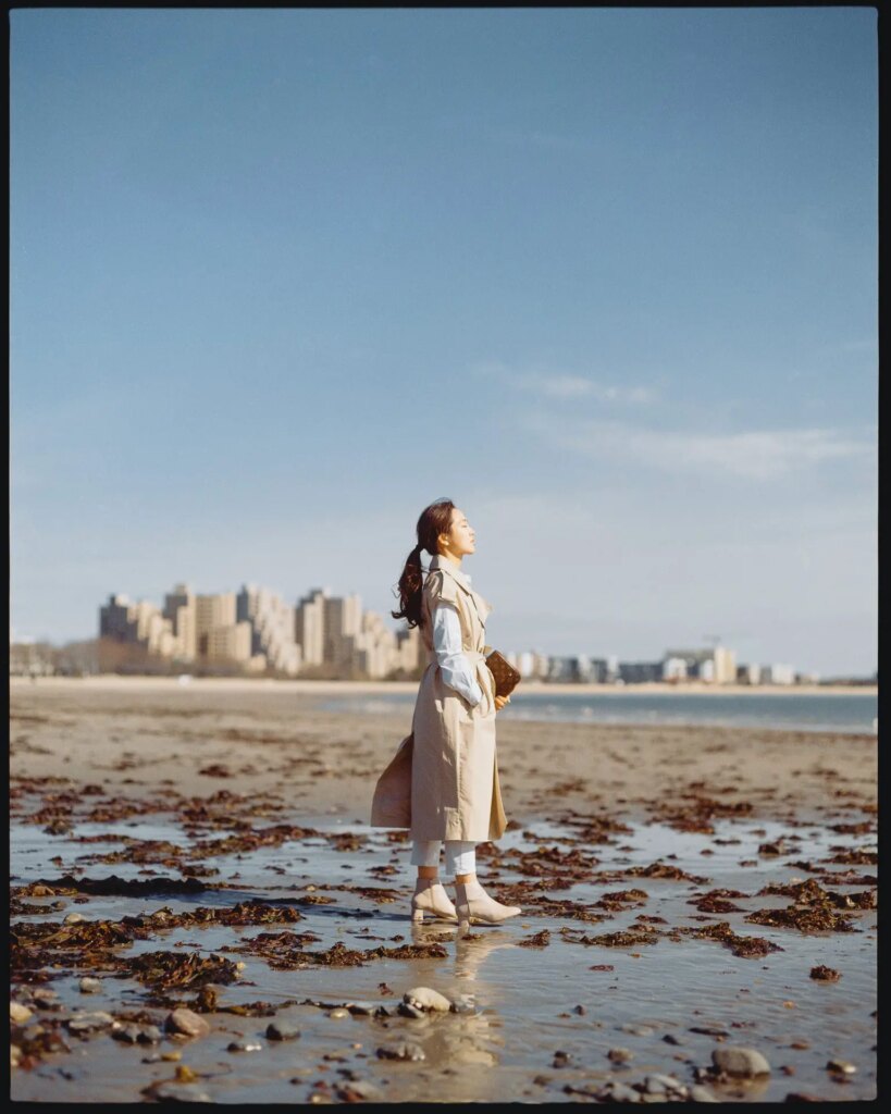woman walking on beach on sunny day