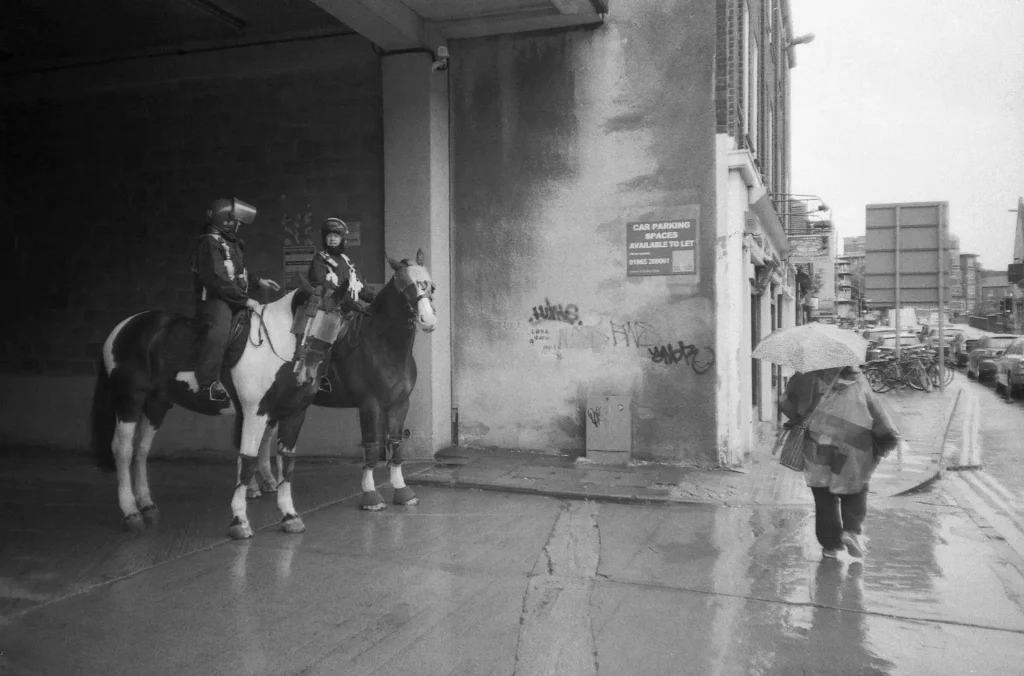 Photo of Police officers on horses made with Canon Sure Shot Sleek camera