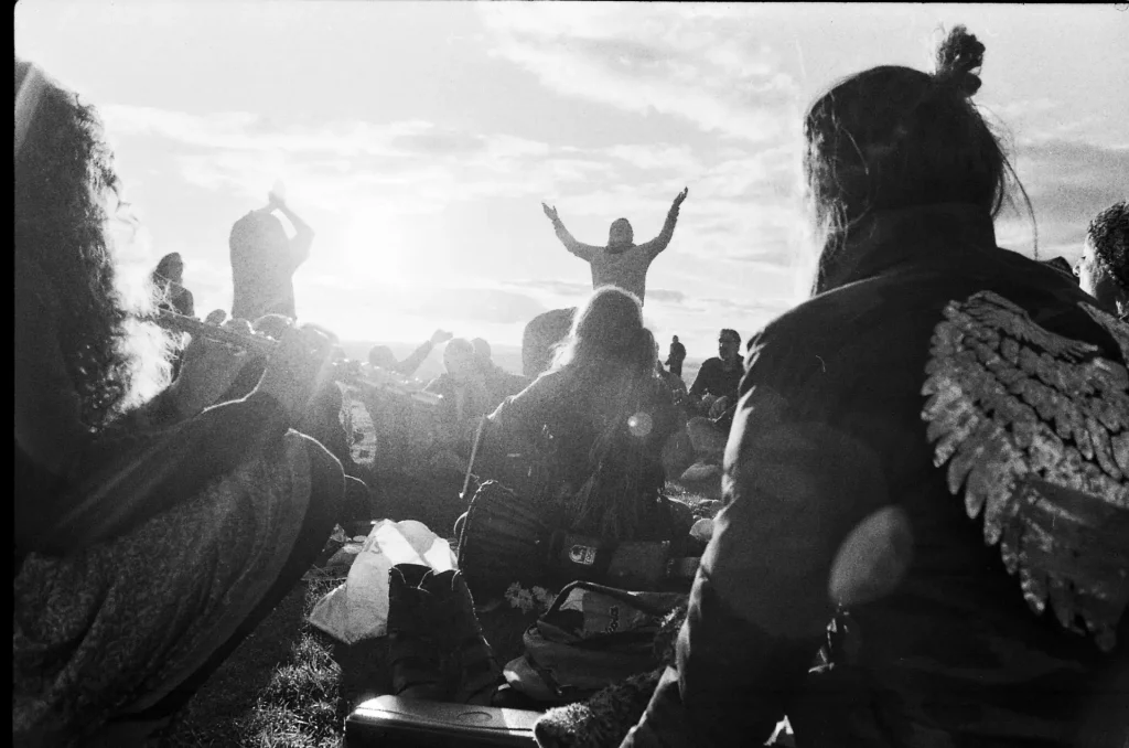 Devotees gather at the summit of Glastonbury Tor at sunset.