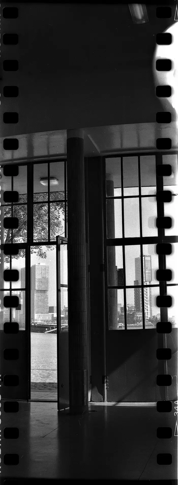 Vertical panorama showing skyscrapers through a glass facade