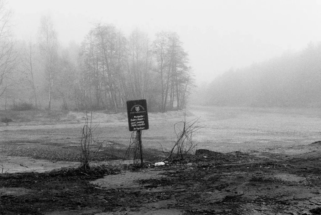 A drained pond in the morning haze.