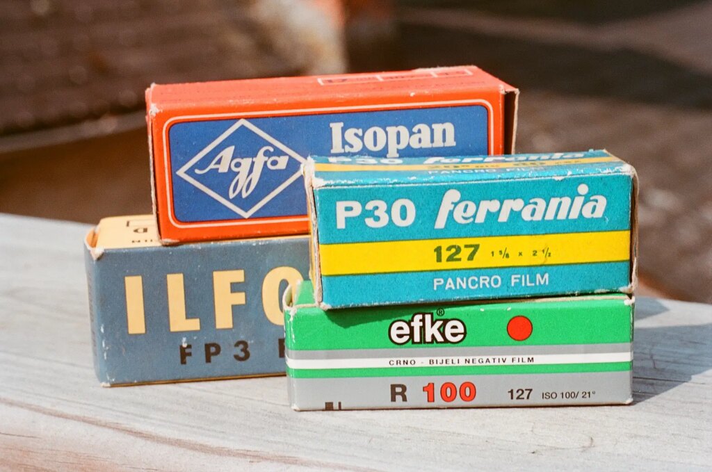 boxes of old film photographed outdoors with film washi x