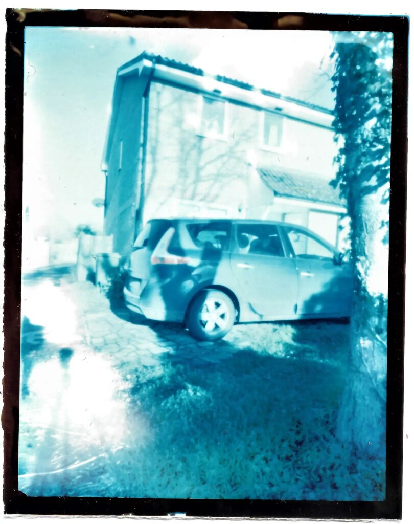 Washed out RA4 pinhole image of a car and a house