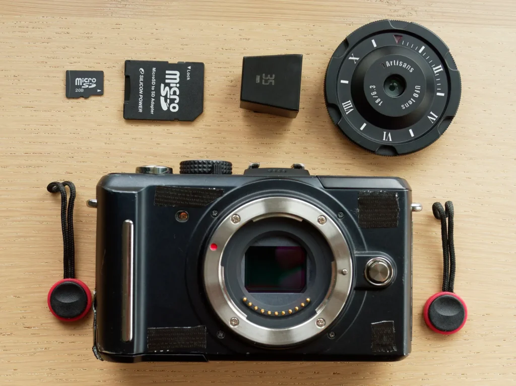 Final Setup of camera, lens, viewfinder, tiny 2GB card and strap anchors.