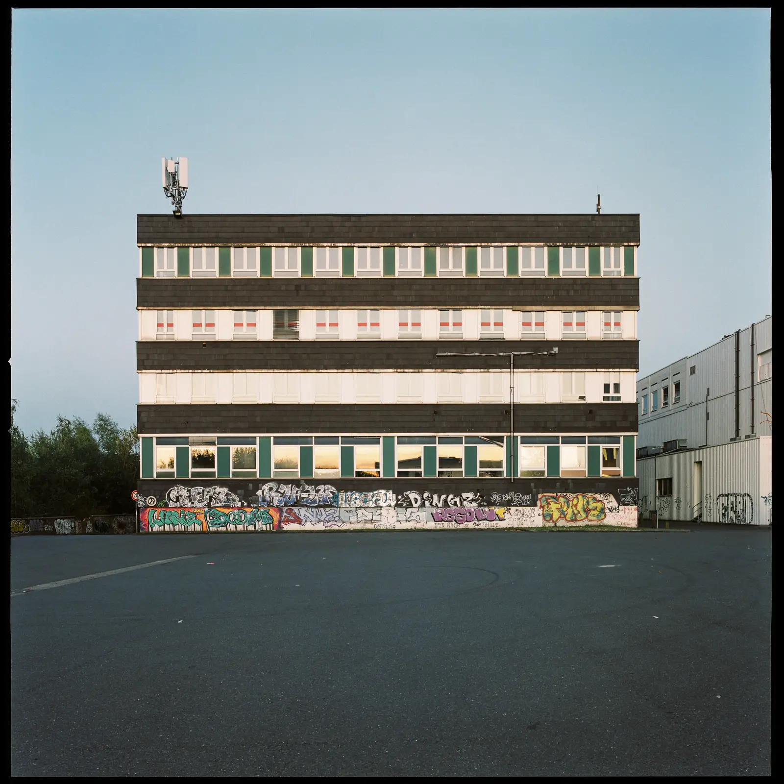 photograph of a rather dull administration building in front of blue evening sky