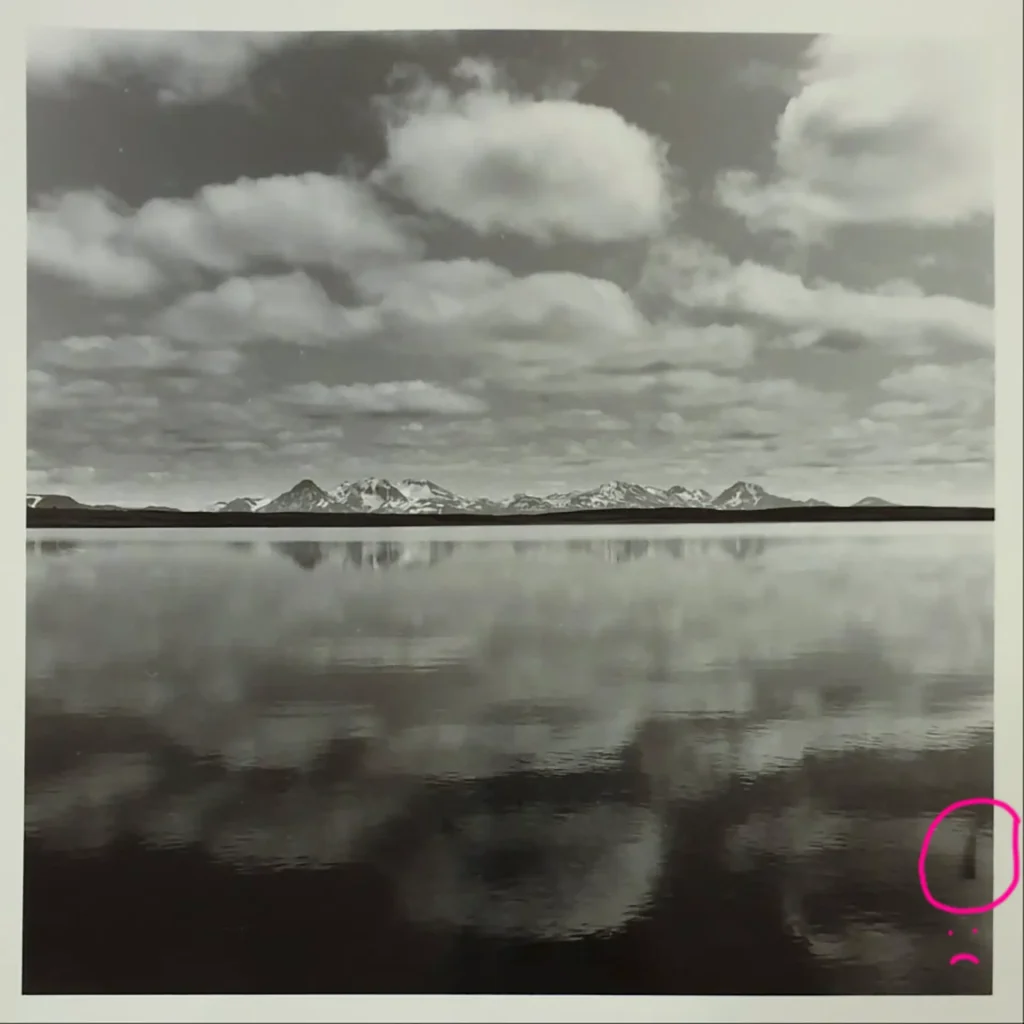 sky and mountains reflected in water