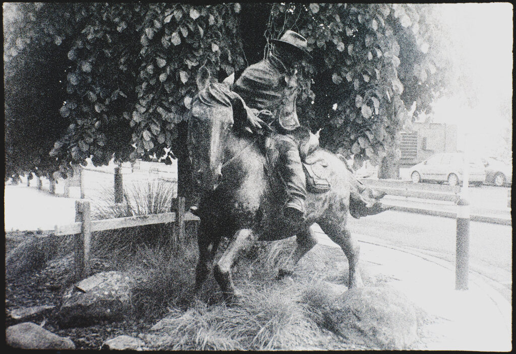 Dull weather shot of Southern Man bronze at entrance to Dunedin airport on Superpan.