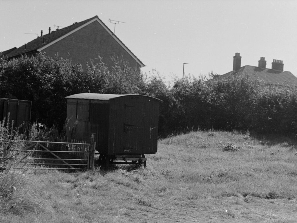 An old train carriage (maybe?) abandoned in a field