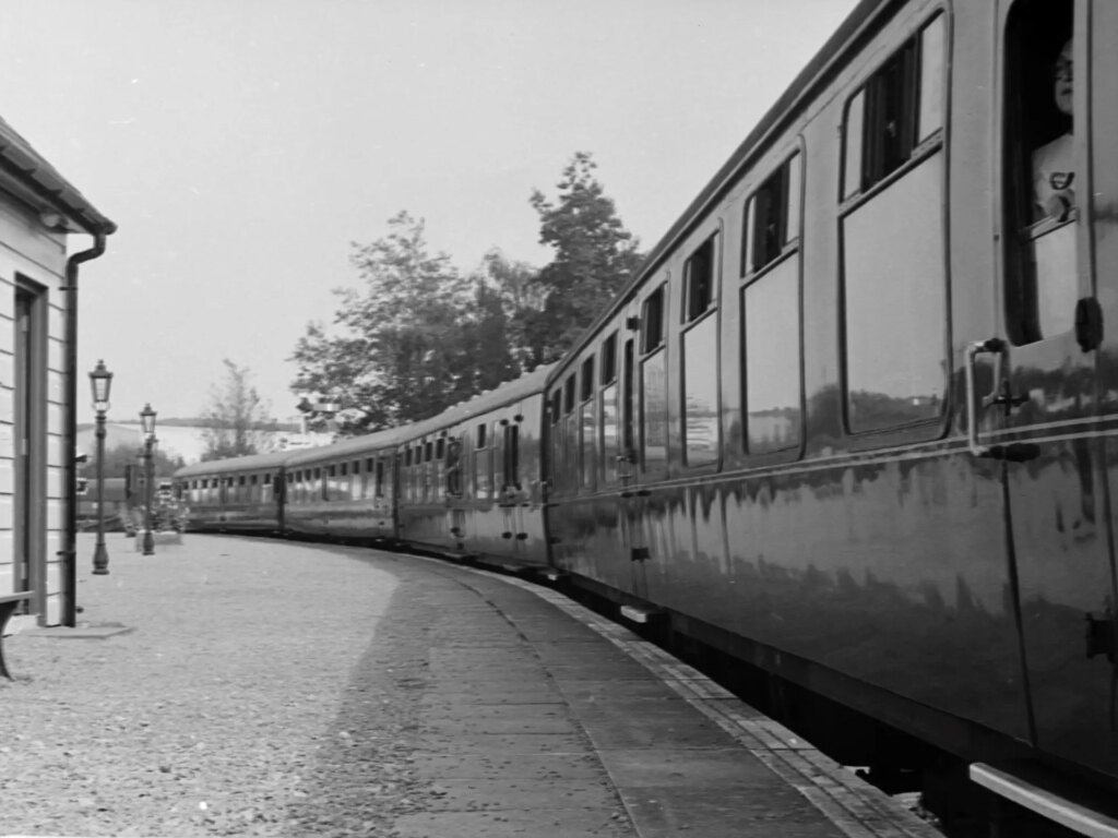 The carriages of the Dean Forest Railway at rest on a station platform curve off into the distance.