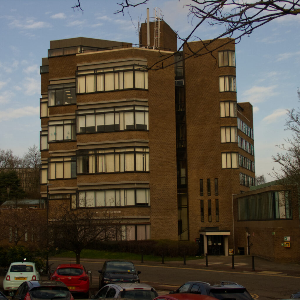 Picture of a brutalist inspired red brick building in winter light. 