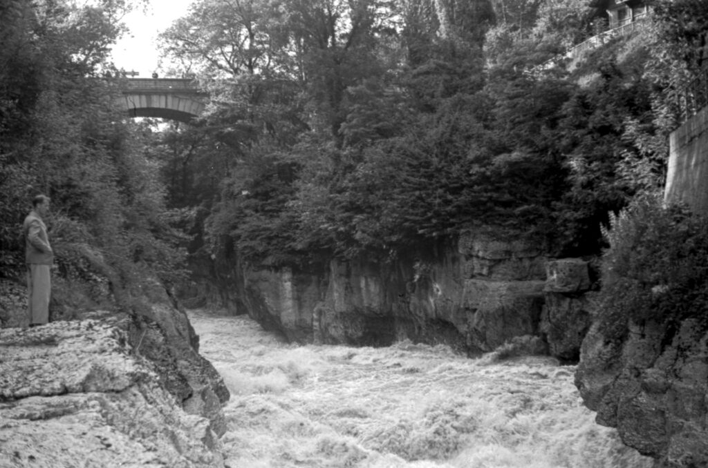 Black and white image of water rushing through a gorge near Annecy, France.