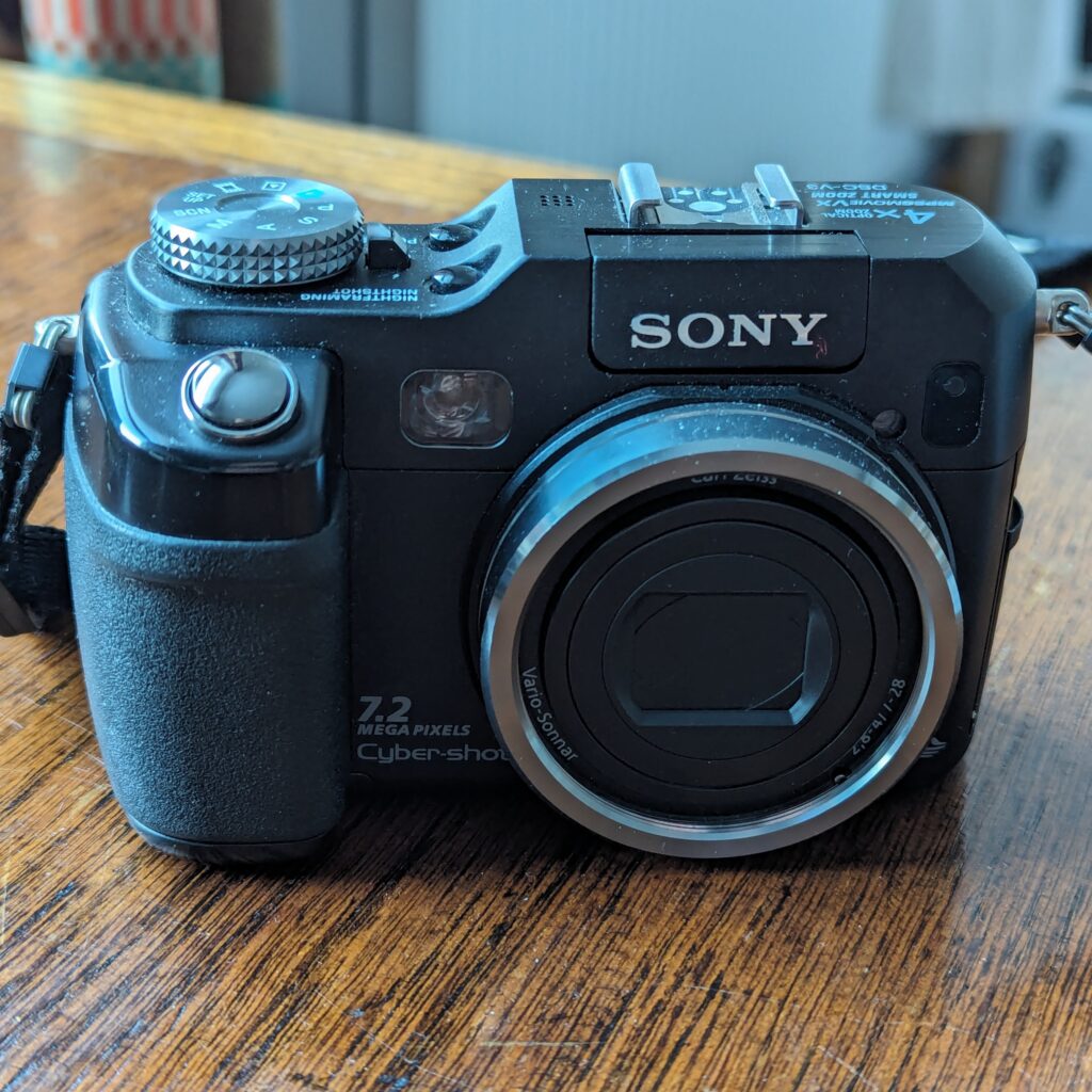 Image of the Sony Cybershot DSC-V3 Camera on a wooden desk