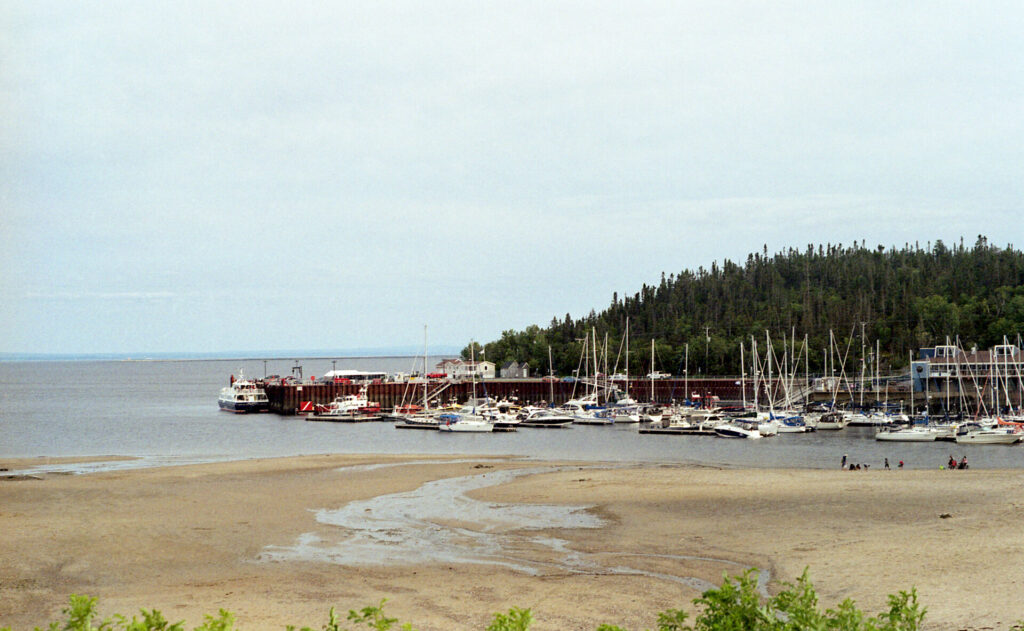 Sandy beach with marina behind